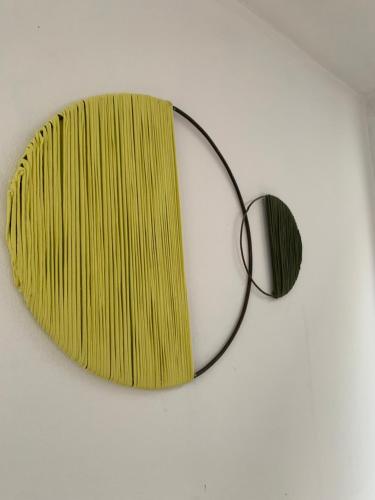 a mirror on a wall with a yellow at Hostel Casa Blanca in San Luis