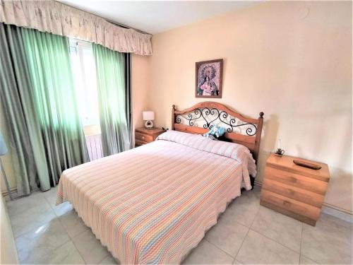 a bedroom with a bed and a dresser and window at Villa Service - Prat de Calafell in Calafell