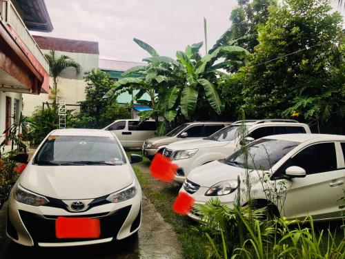 a row of cars parked in a parking lot at Perlies Inn Studio House with NETFLIX in Tanay