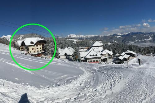 a green circle on top of a snow covered village at The Mountain Home in Hermagor