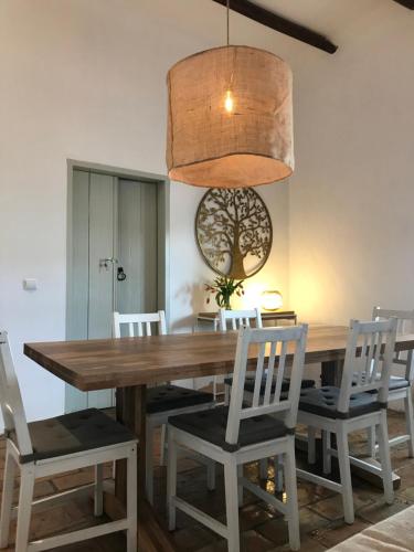 - une salle à manger avec une table et des chaises en bois dans l'établissement Casa Largo do Poço Guesthouse, à Alvor