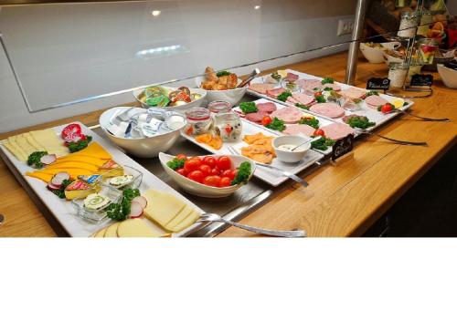a table with many different types of food on it at Hotel Hohenloher Tor in Bretzfeld