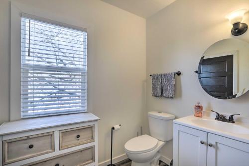 a bathroom with a toilet and a sink and a window at Pet-Friendly Home Rental Near Notre Dame! in South Bend