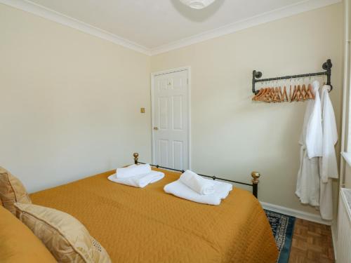 a bedroom with a bed with two towels on it at See The Sea in Hunstanton