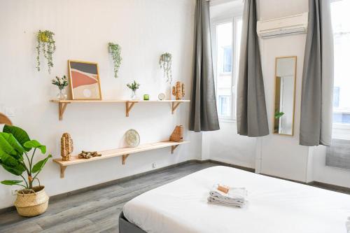 a bedroom with white walls and wooden shelves at Vieux-Port Grand appartement 2 ch avec terrasse in Marseille