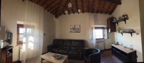 a living room with a couch and a table at Villa Schiatti in Cortona