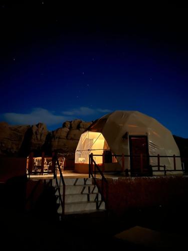a large dome tent in the desert at night at Orbit camp in Wadi Rum