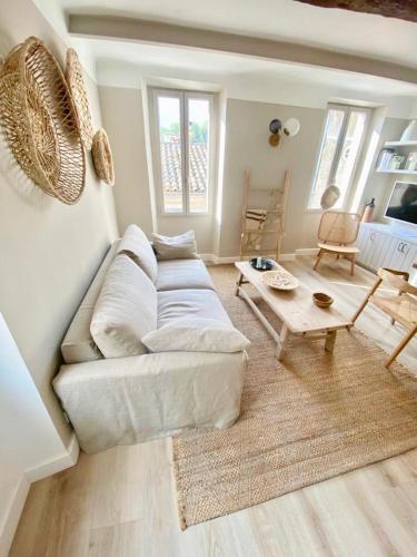 a living room with a white couch and a table at MAISON NOMADE Valbonne in Valbonne