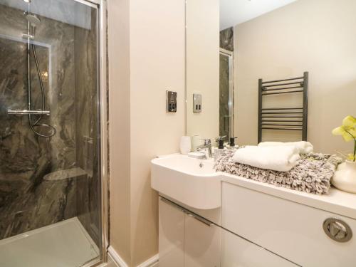a bathroom with a sink and a shower at Shenton Terrace in Buxton