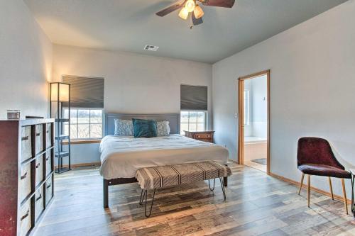 a bedroom with a bed and a ceiling fan at Pet-Friendly Tecumseh Vacation Rental! in Shawnee