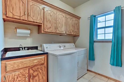 a laundry room with a washing machine and a sink at Pet-Friendly Tecumseh Vacation Rental! in Shawnee