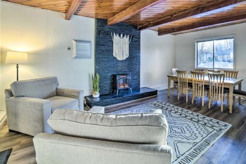 a living room with a couch and a table and a fireplace at Gateway to Mt Rose Ski! Reno Home with Fireplace in Reno