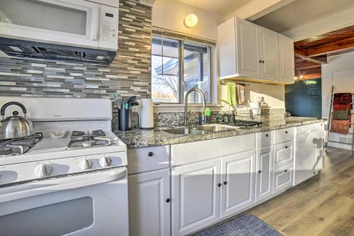 a white kitchen with a stove and a sink at Gateway to Mt Rose Ski! Reno Home with Fireplace in Reno