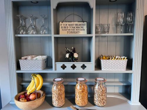 Dores的住宿－Balachladaich Loch Ness B&B，储藏室,储藏有罐子和一碗水果及一篮香蕉