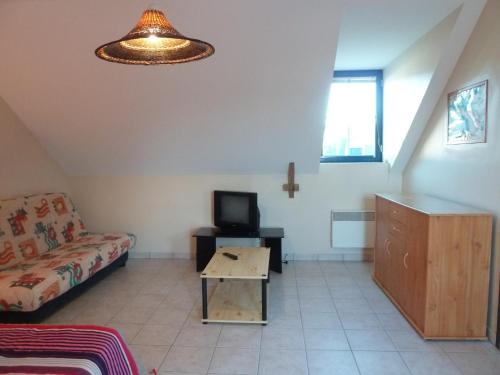 un salon avec un canapé et une télévision dans l'établissement Résidence Au Soleil Breton Pentrez, à Pentrez