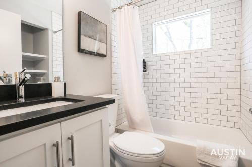 a white bathroom with a sink and a toilet at Bright Space Close To Best Beer Gardens Coffee in Austin
