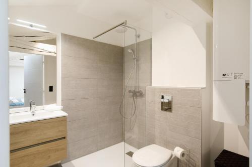 a bathroom with a shower with a toilet and a sink at Snow YourHostHelper in Cannes