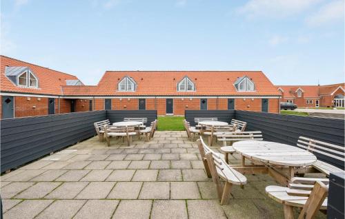 a patio with tables and chairs and a building at Gorgeous Apartment In Lemvig in Lemvig