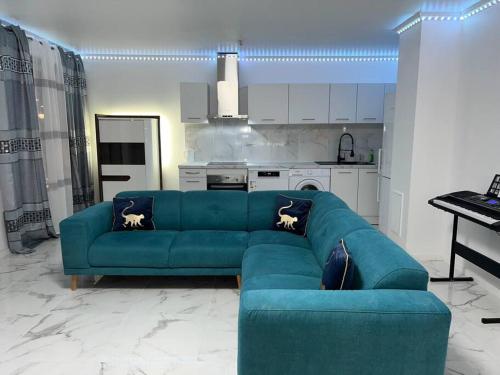Il comprend un salon avec un canapé bleu et une cuisine. dans l'établissement appartement luxueux 70m2, 2 chambres, à Argenteuil