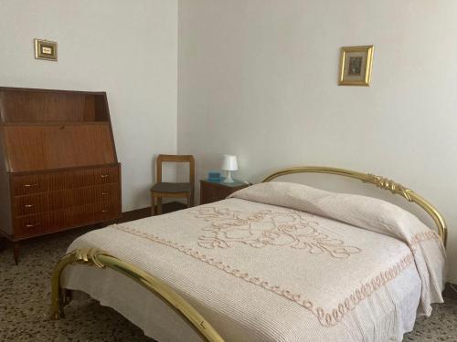 a bedroom with a bed and a dresser and a chair at Affittacamere Ponte di Marmo in Livorno