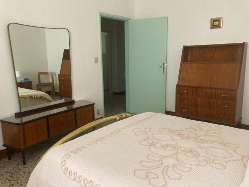 a bedroom with a bed and a large mirror at Affittacamere Ponte di Marmo in Livorno