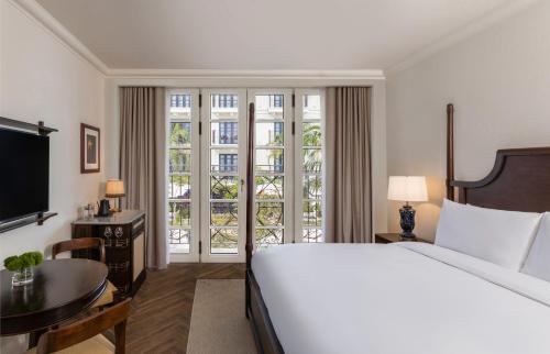 a bedroom with a large bed and a large window at Sofitel Legend Casco Viejo, Panama City in Panama City
