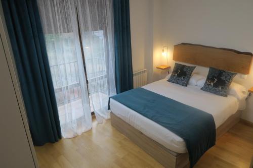 a bedroom with a bed and a large window at Apartamento Calle San Isidro 1ºA in Ezcaray