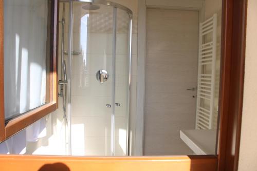 a shower with a glass door in a bathroom at PIUMABLU in Campi Bisenzio