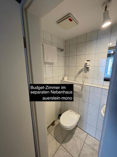 a bathroom with a toilet in a room at AUERSTEIN-Hotels auerstein & auerstein-mono in Heidelberg