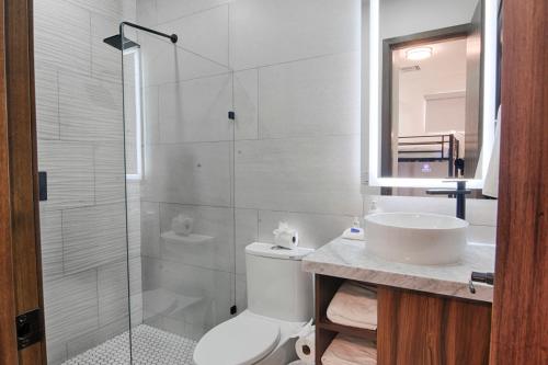a bathroom with a shower and a toilet and a sink at Esmeralda Beach Resort in Puerto Peñasco