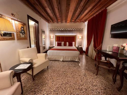 a hotel room with a bed and a desk at Ruzzini Palace Hotel in Venice