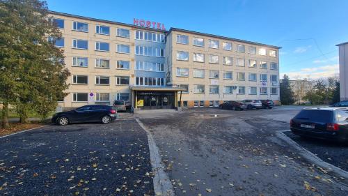 a building with a parking lot in front of it at Hostel Nele in Jõhvi