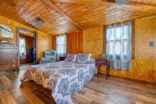 a bedroom with a bed and a wooden ceiling at Catskills Cottage with Deck, 7 Mi to Hunter Mtn in Elka Park