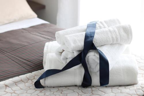a pile of rolled up towels on a bed at PIUMABLU in Campi Bisenzio