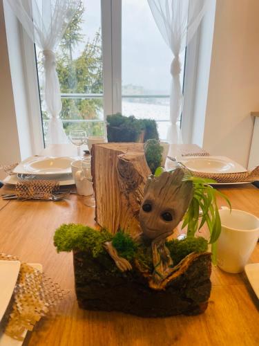 a table topped with a table centerpiece of a baby groot at Apartamenty Happy & Relax in Bielsko-Biala