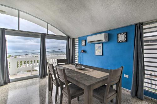 a dining room with a table and chairs and a blue wall at Peaceful Puerto Rico Paradise with Views and Balcony in Fajardo