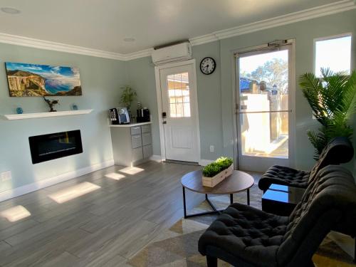 a living room with a couch and a table at Aura Inn Monterey in Monterey