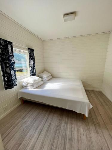 a bedroom with a bed in a room with a window at Trolltunga Studios in Odda