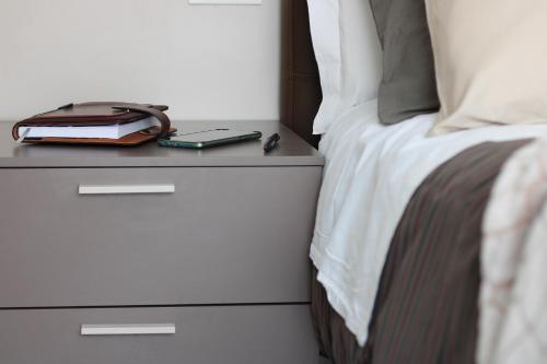 a bed with a night stand with a book on it at PIUMABLU in Campi Bisenzio