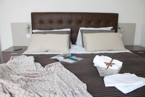 a bed with a blanket and towels on it at PIUMABLU in Campi Bisenzio