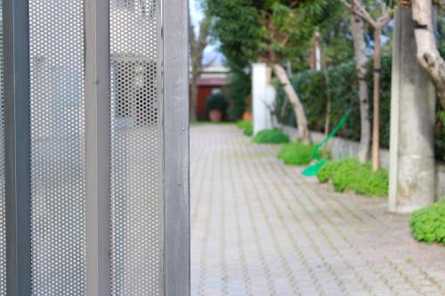 a metal gate with a walkway in a garden at PIUMABLU in Campi Bisenzio