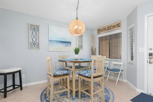 a dining room with a table and chairs at Windjammer 403 in Cedar Landing