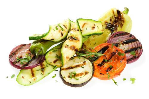 a plate of food with vegetables on a white background at Schlosshotel Marienbad in Mariánské Lázně