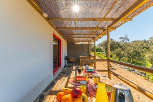 a table on the balcony of a house at Sierra Melides Villa,Alentejo, BR2 with private pool, BR3 with private pool - near beach in São Francisco da Serra