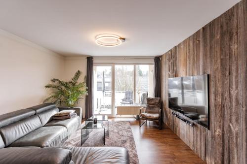 a living room with a couch and a flat screen tv at Wohnen im Zentrum in Lindlar