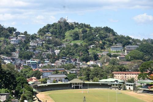 Blick auf eine Stadt mit einem Tennisplatz auf einem Feld in der Unterkunft Cozy Homestay Kandy in Kandy