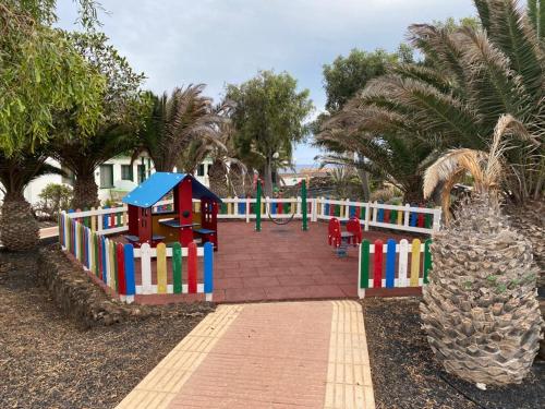a park with a playground with a colorful play area at CASA SANDRA COCOSOL in Costa de Antigua