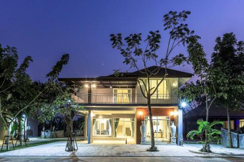 a house at night with lights at Happy Land Residence in Ban Nam Cham