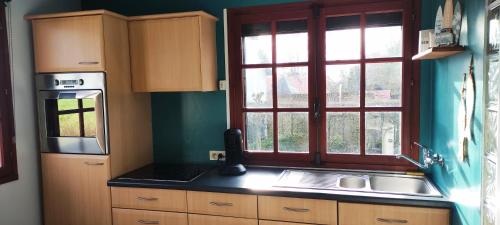 a kitchen with a sink and a window at Le Bout des Dunes, baie de Somme in Saint-Quentin-en-Tourmont