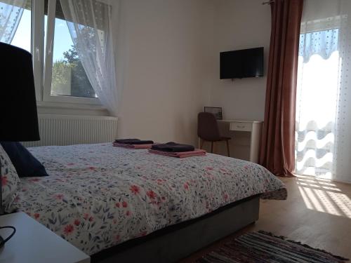 a bedroom with a bed and a desk and a window at Seoski turizam Stari mlin na Korani room 1 in Karlovac